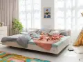 Ein gemütliches Familienbett mit Spielzeug und Kuscheltieren, das zum Kuscheln einlädt. Hier ist Platz für die ganze Familie.