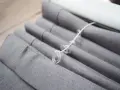 Grauer Raffrollo Stoff mit Schnüren und Ringen, bereit zum Raffrollo waschen.