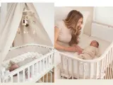 Ein Babybett neben dem Elternbett. Ein süßer Säugling schläft friedlich, während eine Mutter ihr Neugeborenes im Arm hält.